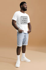Man modelling a white "Trans Sports Fitness" t-shirt, standing confidently in a photo studio with hands in pockets