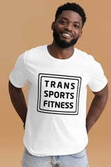 Person wearing a white "Trans Sports Fitness" t-shirt with bold black text, standing against a neutral background